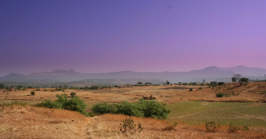 Adventurous visitors skydiving over Aamby Valley, a private hill station offering various thrilling activities.