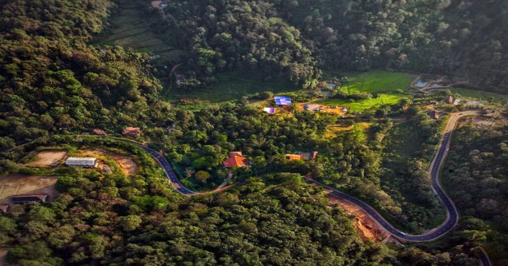 Trekking through lush green hills and forests in Coorg, often referred to as the Scotland of India.