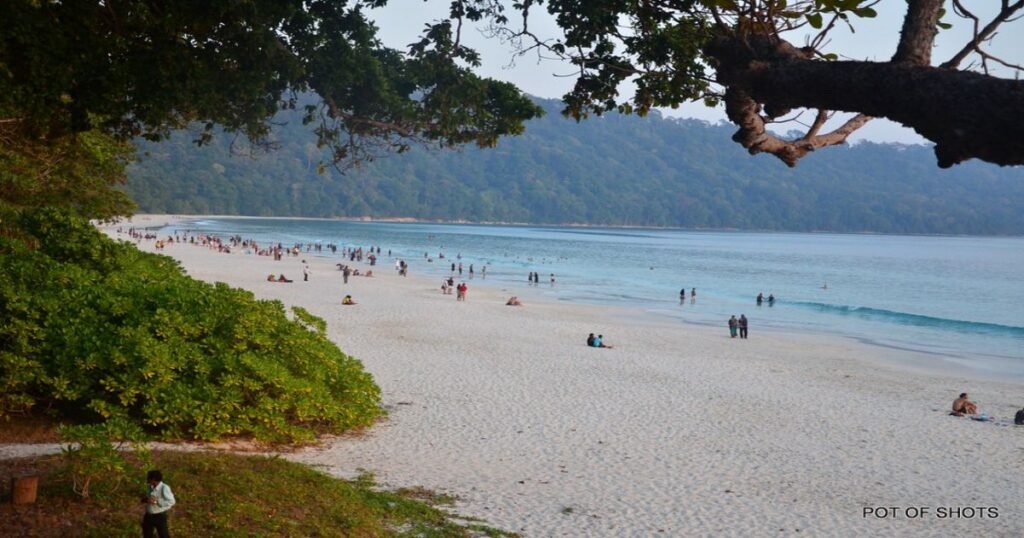 Andaman and Nicobar Islands, featuring pristine white sand beaches, clear blue waters, and lush tropical greenery.