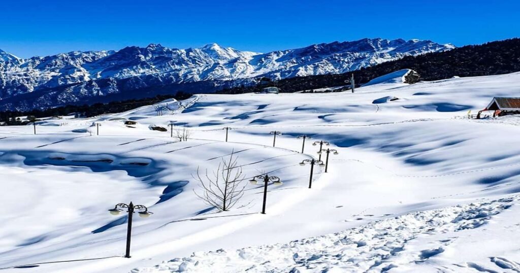 the snowy slopes of Auli with Himalayan peaks in the background