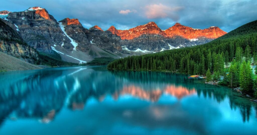 **Image Alt Text:** A panoramic view of turquoise Lake Louise surrounded by snow-capped mountains in Banff National Park.