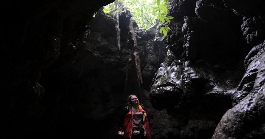 Explorers navigating through one of Meghalaya's famous caves, known for its extensive cave systems.