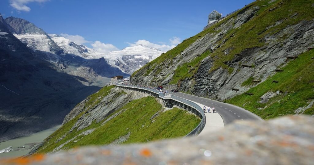 “Cyclists riding along the winding Grossglockner High Alpine Road with panoramic views of Austria’s highest peaks.”