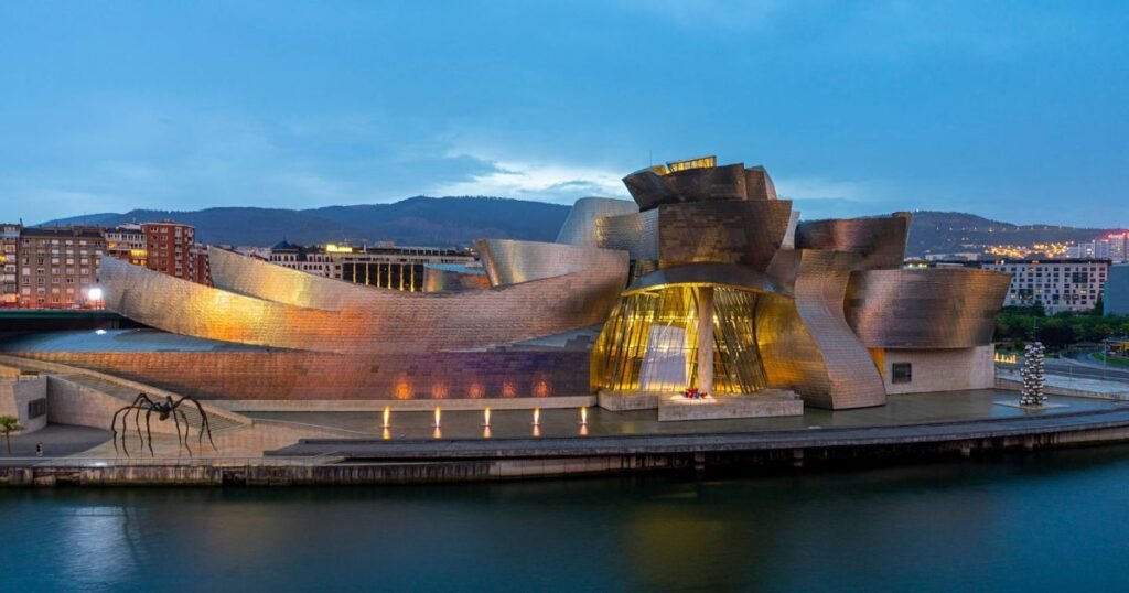  The unique titanium exterior of the Guggenheim Museum in Bilbao, reflecting the light of the sky and water.