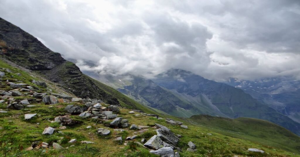 “A group of hikers trekking through the snow-capped peaks and verdant valleys of Hohe Tauern National Park.”
