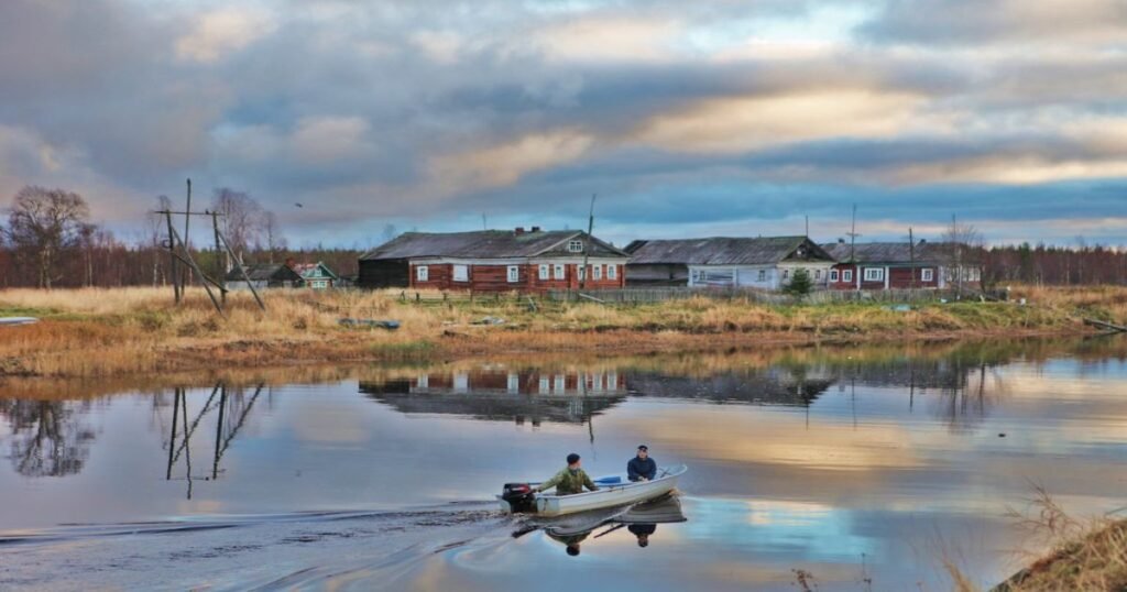 “Kayakers paddling through a serene lake surrounded by dense forests in Karelia.”