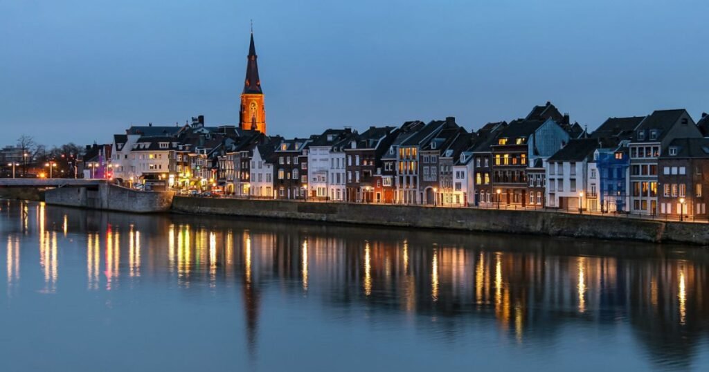  The cobblestone streets and old buildings of Maastricht with the Basilica of Saint Servatius visible in the background.