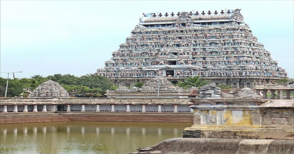 The colorful and intricately carved gopuram of Meenakshi Temple rising above the bustling city of Madurai.