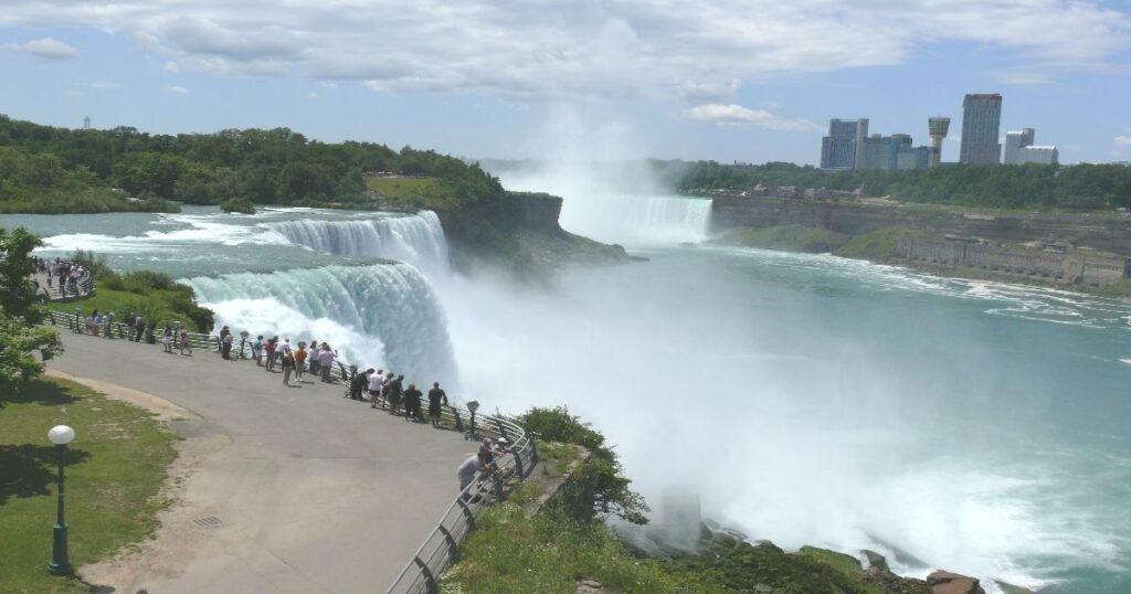 A panoramic view of Niagara Falls with mist rising from the falls’ base.