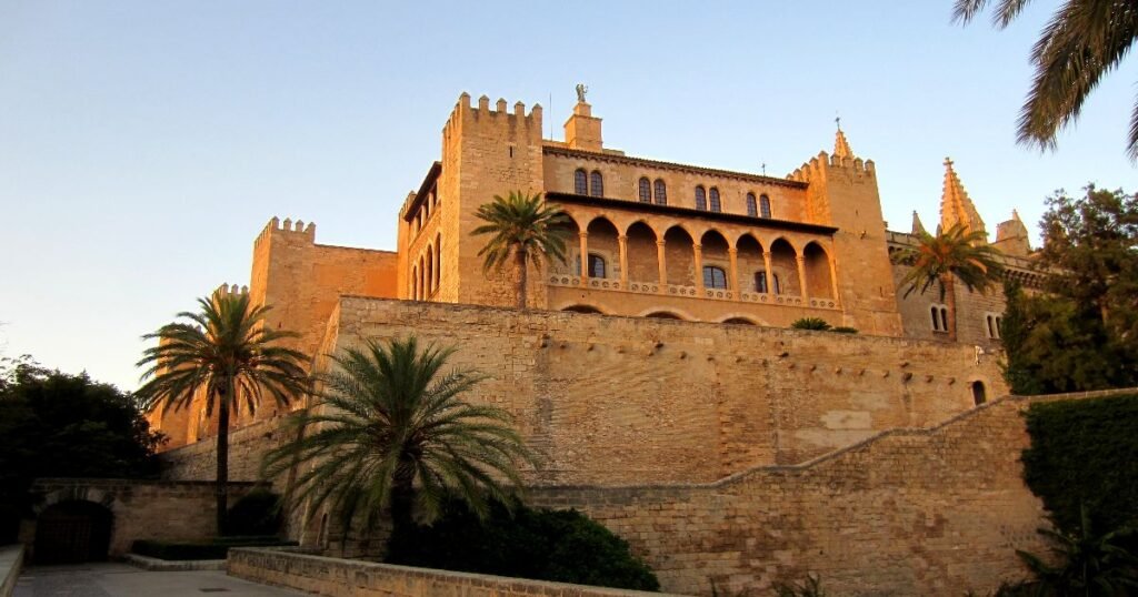 The grand Royal Palace of La Almudaina overlooking the waterfront in Palma de Mallorca.