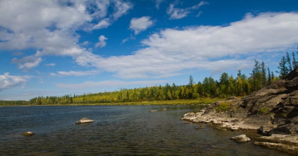 “A breathtaking view of the vast and rugged landscape of the Putorana Plateau dotted with waterfalls and lakes.”