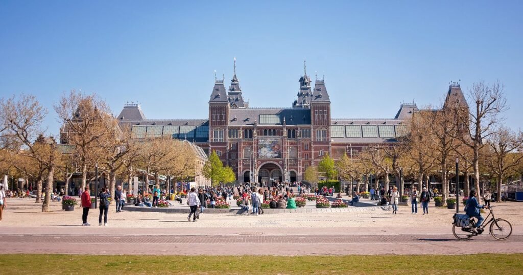 The grand façade of the Rijksmuseum with its iconic arches and red-brick architecture in Amsterdam.