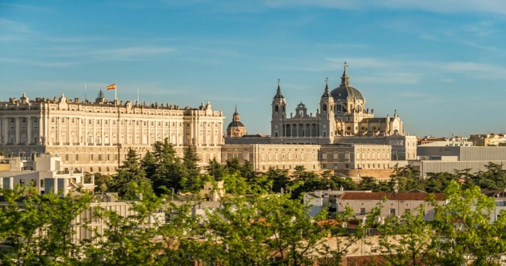 The majestic Royal Palace of Madrid, with its grand façade and lush gardens.