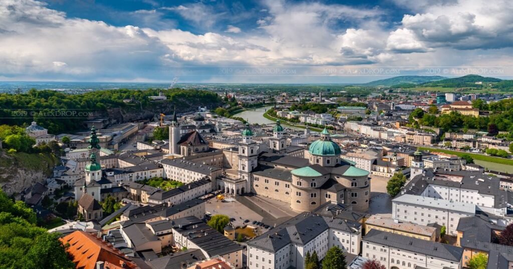 The historic Old Town of Salzburg with its Baroque buildings and the Hohensalzburg Fortress looming on the hilltop.