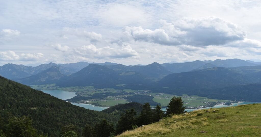  A red cog railway ascends the scenic Schafberg mountain with panoramic views of the Austrian Alps and lakes.