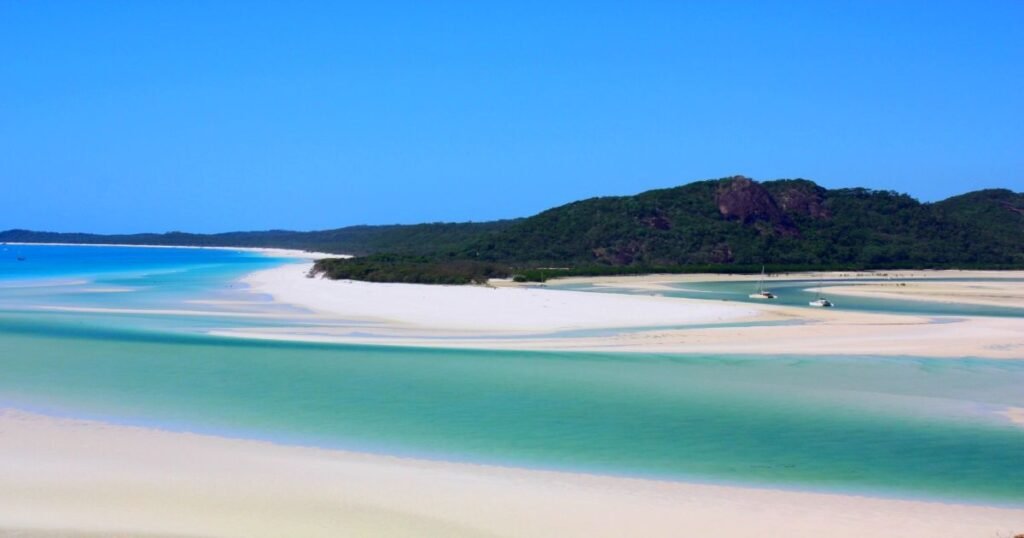  Pristine white sand and turquoise waters of Whitehaven Beach on Whitsunday Island.