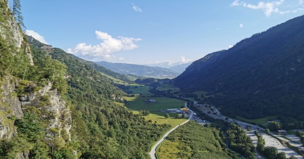 “Panoramic view of Zell am See’s lush green hills in the backdrop.”