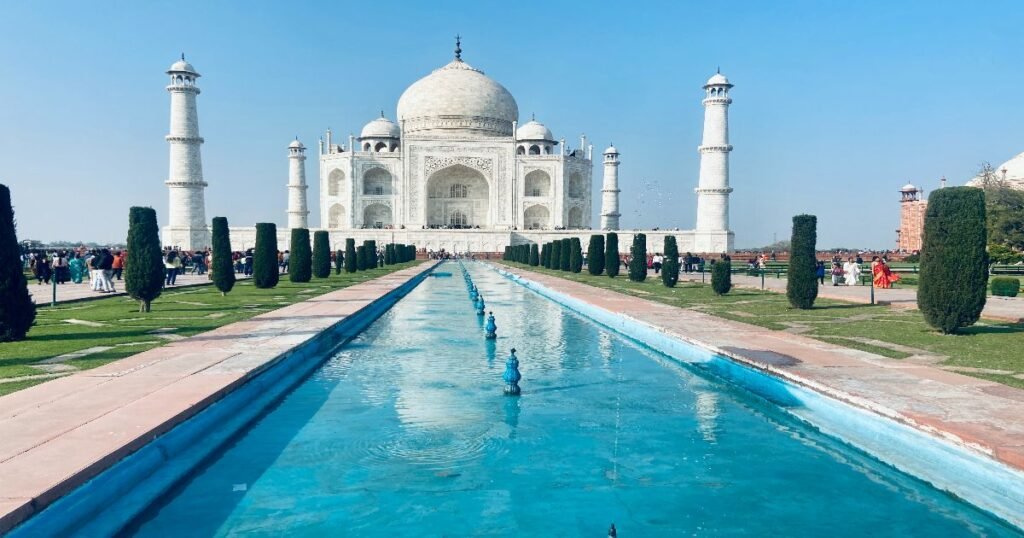 The Taj Mahal, a white marble mausoleum with lush gardens and a reflecting pool.