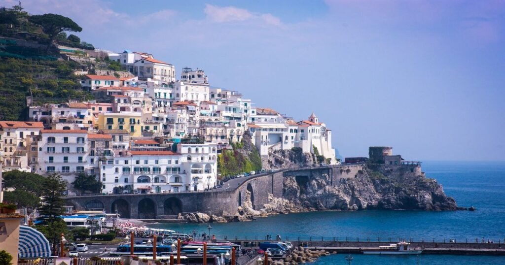 “Picturesque Amalfi Coast with colorful houses perched on cliffs overlooking the Mediterranean Sea.”