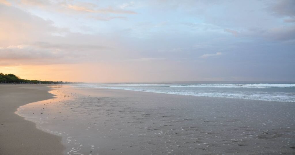  "Golden sands and clear blue waters at a beach in Bali during sunset."