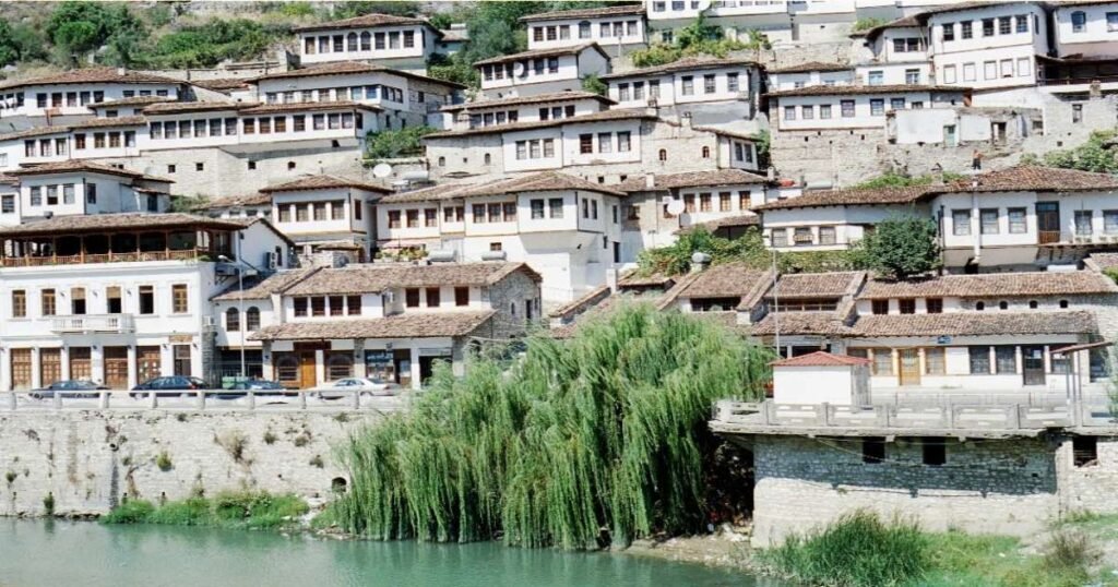  "Historic hillside houses of Berat overlooking the Osum River."