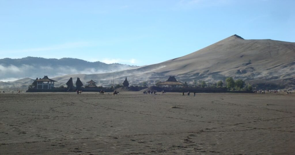 "Fog rolling over the volcanic landscape of Mount Bromo in the Bromo Tengger Semeru National Park."