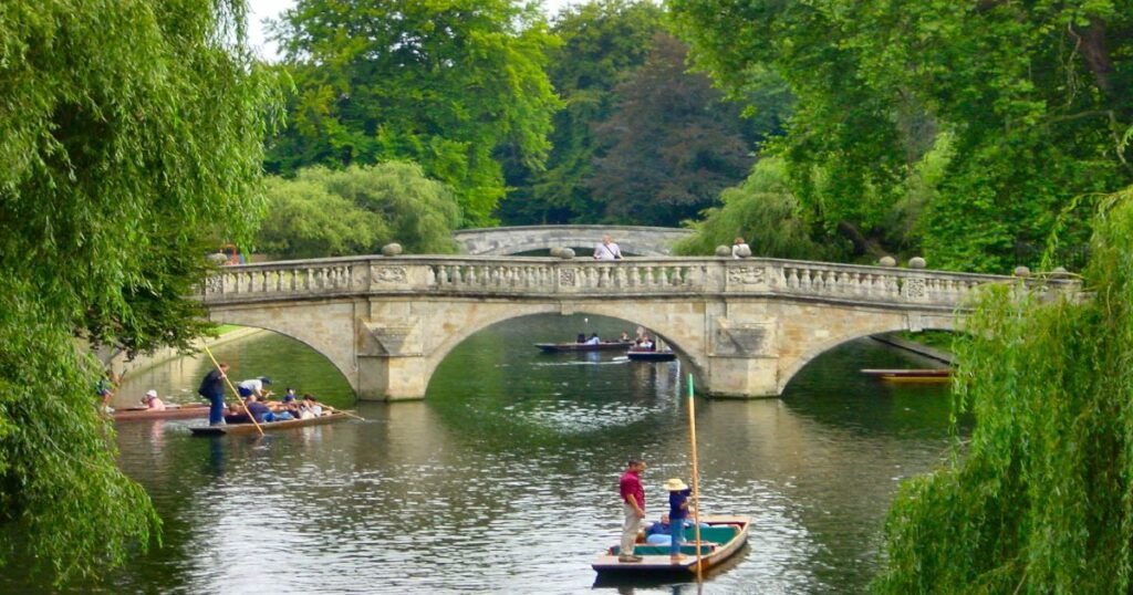 “Cambridge University’s King’s College Chapel and the tranquil River Cam, with punts floating beneath arched bridges.”