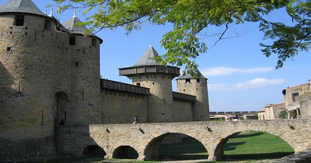 The medieval fortress of Carcassonne illuminated at sunset, with its imposing towers and walls