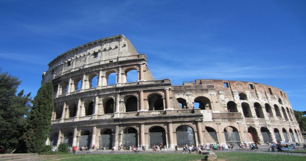 “Colosseum in Rome, a grand amphitheater with towering stone arches and historical grandeur.”