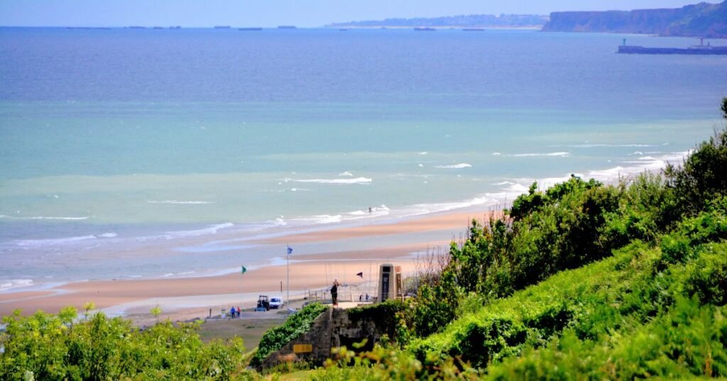 The serene sands of Omaha Beach in Normandy.