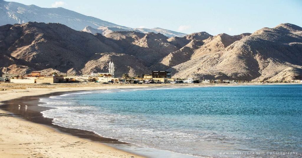 Divers exploring the beach around Dibba Rock.