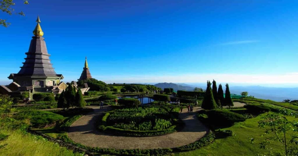 “Twin pagodas surrounded by blooming flowers at the top of Doi Inthanon, Thailand’s highest peak.”