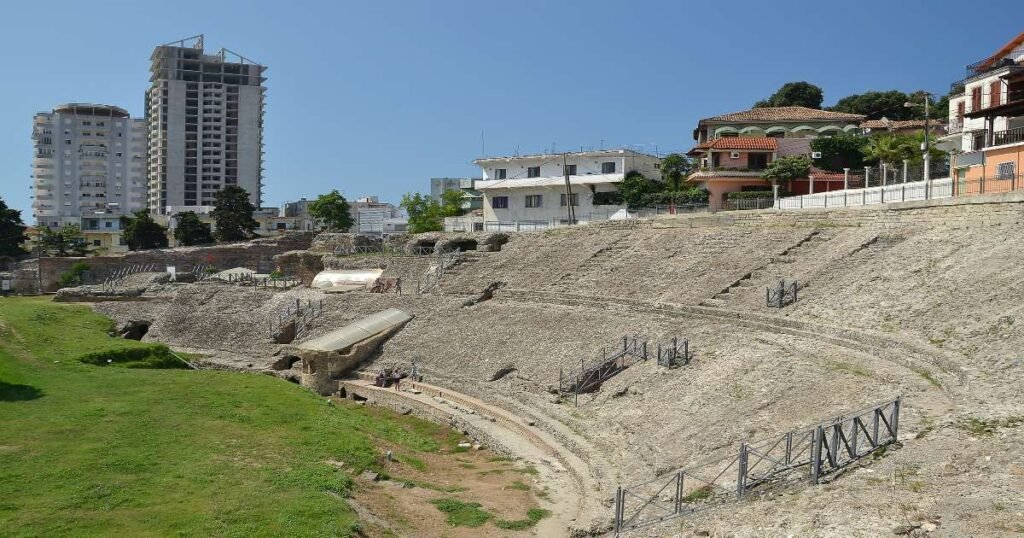 "Ruins of the Roman amphitheater in Durrës under a clear blue sky."