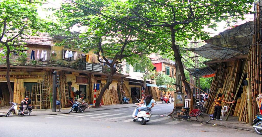 "Busy streets of Hanoi’s Old Quarter lined with traditional shops and street vendors."