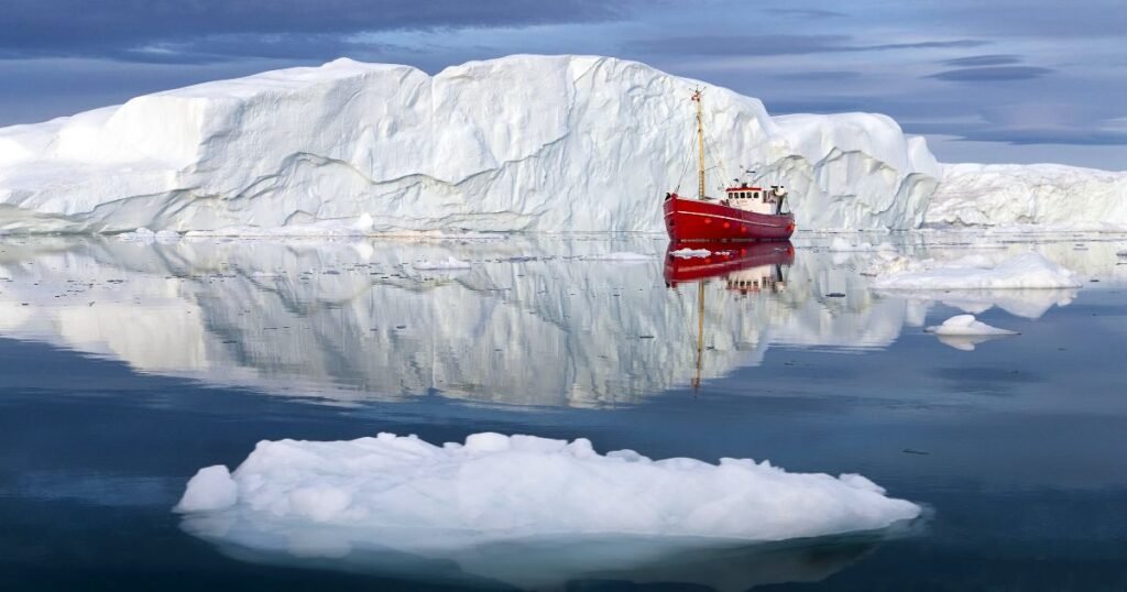 “Ilulissat Icefjord, with towering icebergs against a backdrop of rugged mountains and pristine waters.”