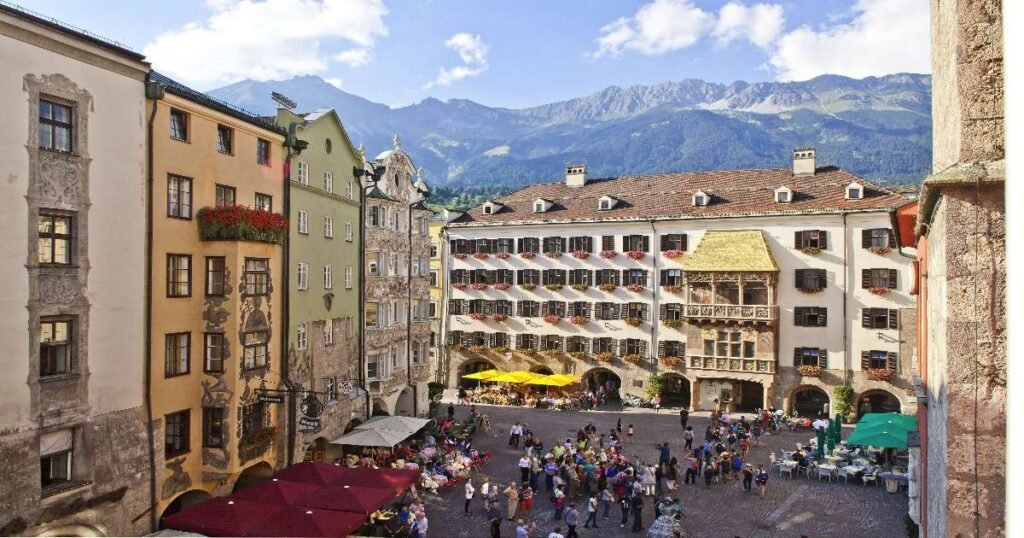 “The picturesque streets of Innsbruck’s Old Town, with colorful buildings and the Golden Roof shining in the distance.”