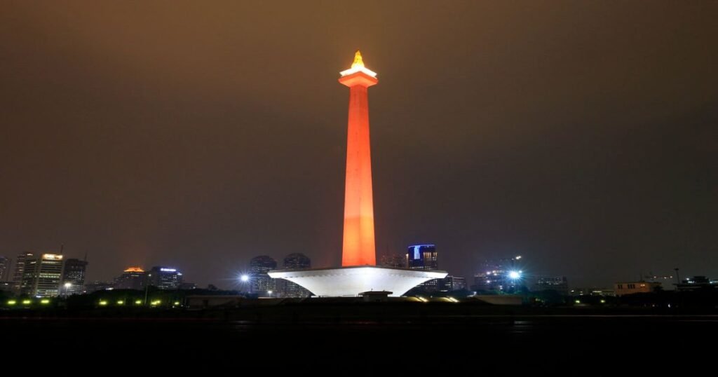 "Jakarta’s National Monument Glowing Brightly In Night Sky."