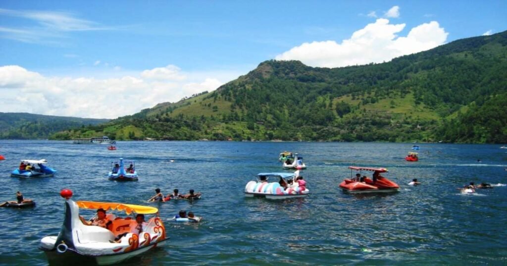 "Lake Toba with green hills and Samosir Island in the distance."