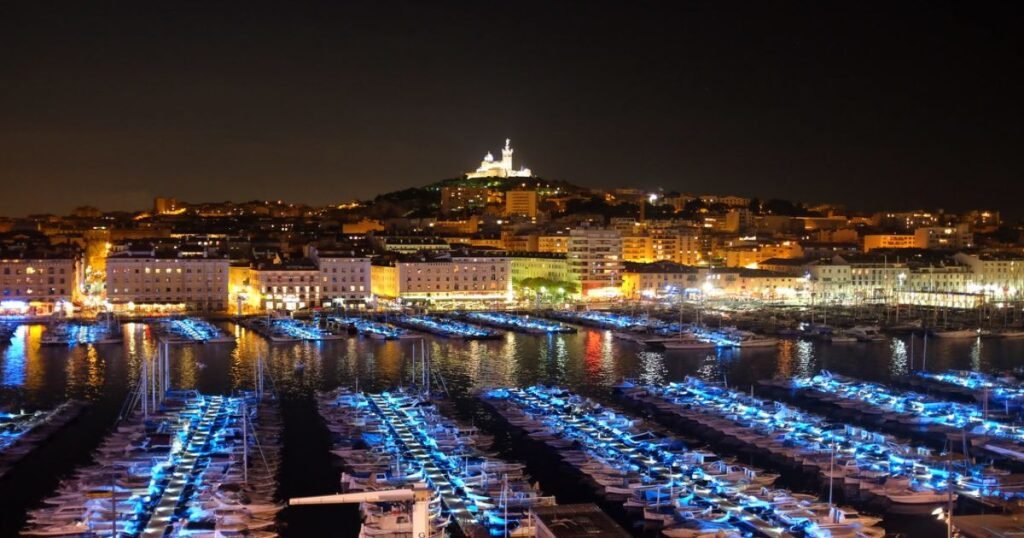 The bustling Vieux-Port of Marseille, lined with boats and surrounded by cafes and restaurants.