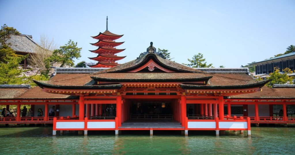 "The floating torii gate of Itsukushima Shrine on Miyajima Island, with the surrounding sea and mountains in the background."