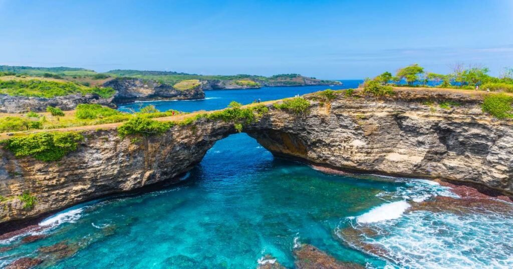 "Stunning cliffs and blue waters of Nusa Penida island."