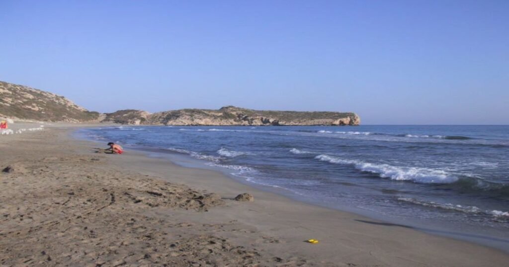 "Pristine golden sands of Patara Beach, with the turquoise Mediterranean Sea and distant mountains."