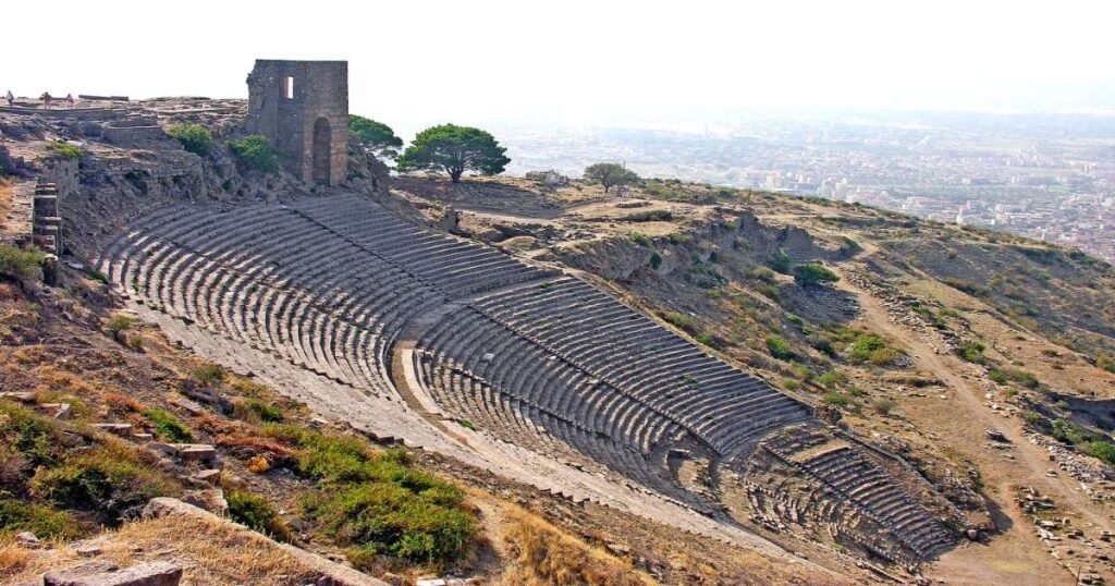 "The ancient Acropolis of Pergamon, with ruins of temples and theaters perched on a hilltop overlooking the valley."