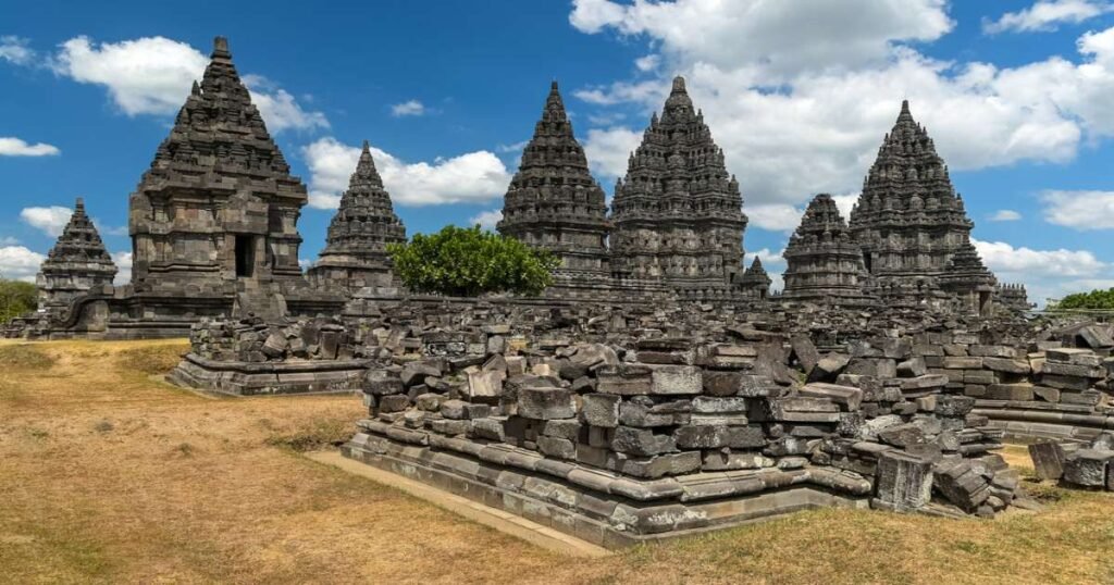 "Prambanan Temple complex with majestic stone towers against a clear blue sky."