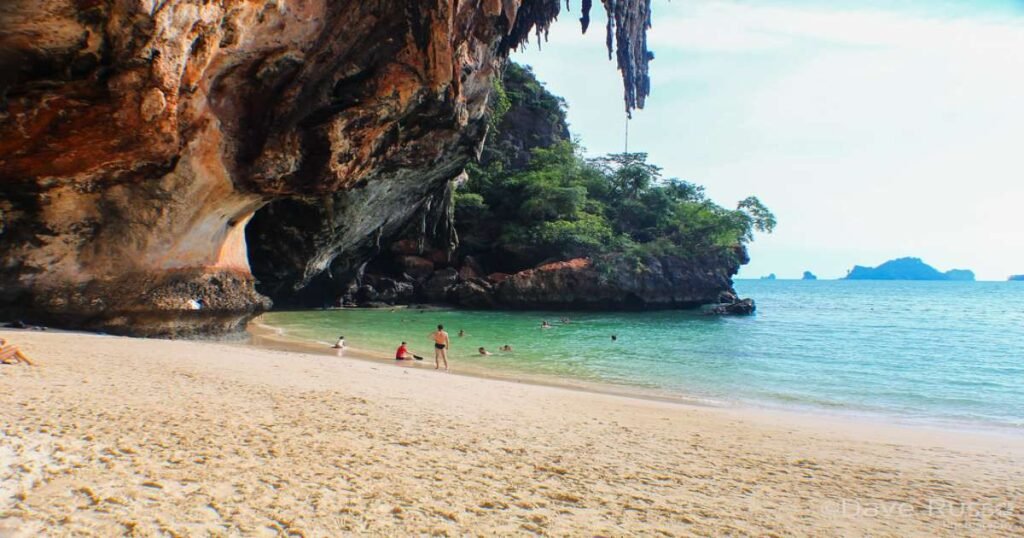 “Towering limestone cliffs at Railay Beach with clear turquoise.