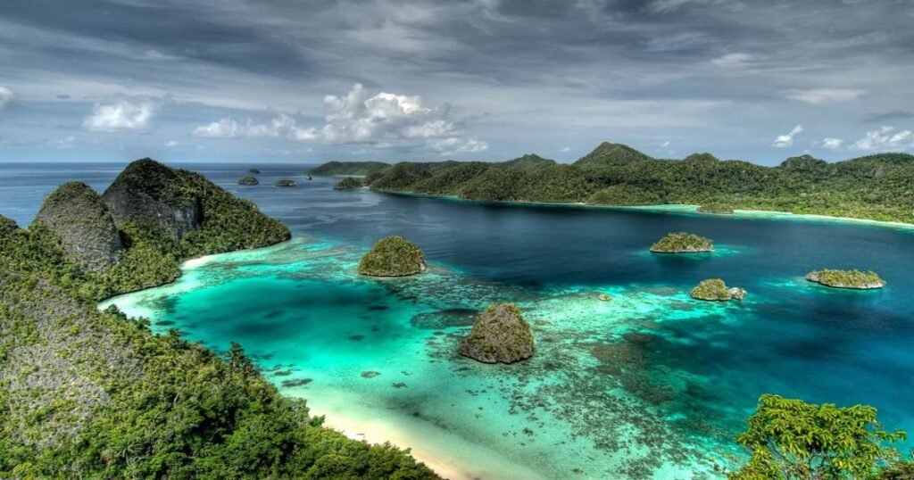 "Turquoise waters and vibrant coral reefs surrounding the Raja Ampat Islands."