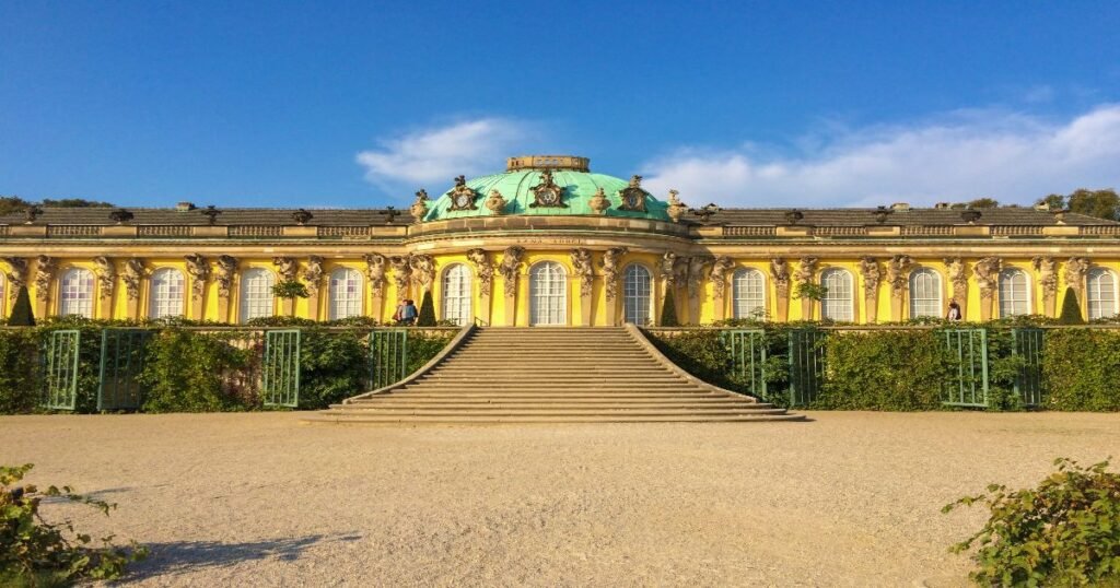 The magnificent Sanssouci Palace in Potsdam, with its grand Rococo facade and lush terraced gardens."