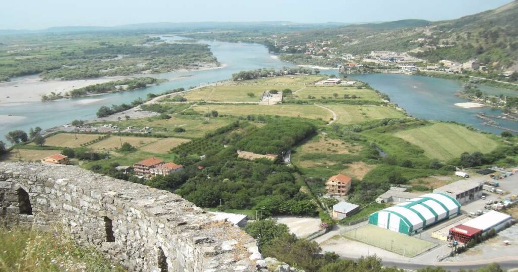  "A scenic view of Shkodra Lake with Rozafa Castle in the distance."