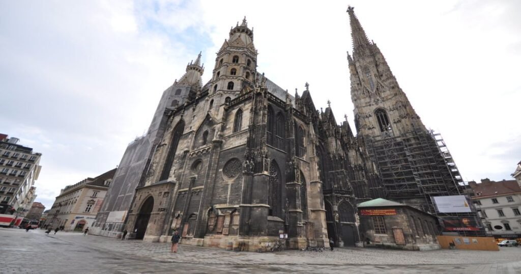 “The intricate Gothic spires of St. Stephen’s Cathedral against a clear blue sky.”
