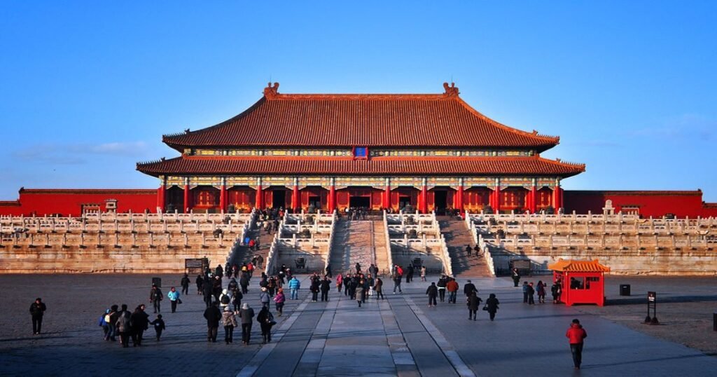 "A stunning view of the Forbidden City's golden rooftops and symmetrical layout."